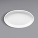 A white oval porcelain souffle dish on a white background.