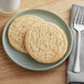 Two Best Maid Thaw and Serve Snickerdoodle cookies on a plate.