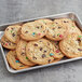 A tray of Best Maid Thaw and Serve Chocolate Chip Cookies with M&M's on them.