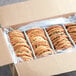 A Best Maid box of Thaw and Serve Chocolate Chunk Cookies with plastic wrapped stacks of cookies inside.