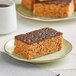 A Best Maid Peanut Butter Crispy Treat with chocolate frosting on a plate.