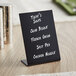 A black Choice tabletop chalkboard sign with white writing on it.