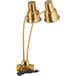 A gold Avantco countertop heat lamp with dual arms and two bulbs.
