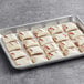 A tray of Brill Strawberry Cream Cheese Mini Strudels on a gray surface.
