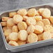 A metal tray of McCain Hash Brown Rounds.