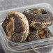 A Greater Knead gluten-free poppy seed bagel in a plastic container.