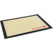 A black and tan de Buyer silicone baking mat with red text and logos.