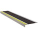 A metal Wooster Flexmaster stair tread with yellow stripes on the edges.