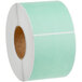 A roll of green and white Lavex mailing labels.
