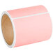 A roll of Lavex pink thermal transfer labels. The roll is pink.