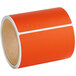 A roll of Lavex orange thermal transfer labels with white strips.