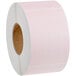 A roll of pink labels with a white background.