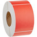 A roll of red Lavex thermal labels with white text on the roll.