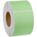 A roll of green labels on a white background.