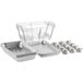 A group of aluminum trays and containers on metal racks.