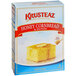 A box of Krusteaz Professional Honey Cornbread and Muffin Mix on a table with a piece of cornbread with butter on top.