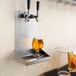 A Regency wall mount beer drip tray with two beer glasses on it.