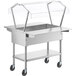 A silver stainless steel ServIt ice-cooled food table with a clear cover over food pans.