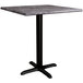 A Lancaster Table & Seating square table with a black base and marble top.