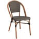 A brown wooden French bistro chair with a grey cushion.