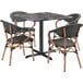 A Lancaster Table & Seating Paladina table with a marble top and four black French bistro chairs.