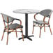 A Lancaster Table & Seating Versilla table with 2 French Bistro chairs.