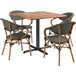 A Lancaster Table & Seating wooden table with a black metal frame and 4 chairs around it.