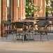 A Lancaster Table & Seating Yukon Oak table and chairs on an outdoor patio.