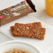 A Kodiak Cakes chocolate chip crunchy granola bar on a plate of breakfast food.