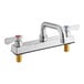 A chrome Regency deck-mounted faucet with silver and red knobs.