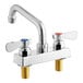 A silver Regency deck-mounted faucet with two handles and a 6" swing spout.