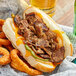 A close up of a sandwich with Original Philly Cheesesteak Co. Wow Seasoned Beef Steaks with cheese and meat.