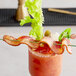 A bloody mary with a bacon stick in it.