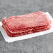 A stack of frozen Original Philly Cheesesteak Co. Wow Seasoned beef sandwich steaks on a white surface.