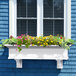 A white Mayne Yorkshire window box with flowers in it.