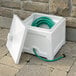 A white box with a green hose inside.