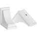 A pair of white plastic corbels with a black circle on the back.