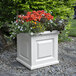 A white square Mayne Nantucket planter with colorful flowers.