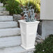A white Mayne Fairfield rectangular planter with plants in it.