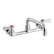 A chrome Regency wall mount faucet with silver and red handles.