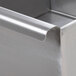 A stainless steel Advance Tabco utility sink with metal corners.