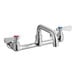 A chrome Regency wall mount faucet with two silver handles and a 6" swing spout.