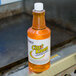 A bottle of Noble Chemical CitraKleen liquid citrus cleaner on a kitchen counter.