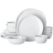 A stack of white American Metalcraft Crave melamine plates and bowls on a white background.