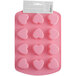 A pink silicone heart candy mold with 12 compartments in a white package with a hole in the top.