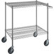 A Regency chrome wire utility cart with two shelves and wheels.