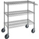 A Regency chrome wire utility cart with three shelves and wheels.