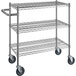 A Regency chrome metal utility cart with three shelves and wheels.