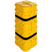 A yellow plastic cylinder with black bands.
