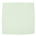 A white microfiber cloth with green trim.